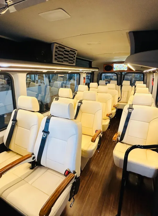 Interior of a Maharaja tempo traveller with cream leather seats